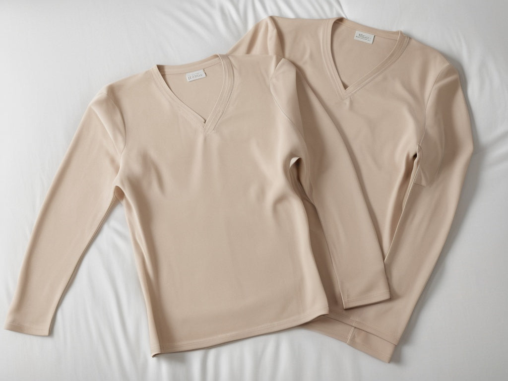 Two beige compression garments laid side by side on a bed